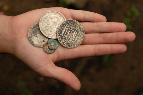 Una de las hijas del descubridor del pequeño tesoro muestra algunas de las monedas que su padre no vendió.