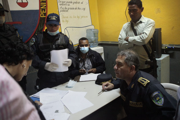 A la derecha, el director de la policía hondureña,Ricardo Ramírez del Cid, ayuda a hacer el recuento final de fallecidos en la tragedia. Foto Frederick Meza