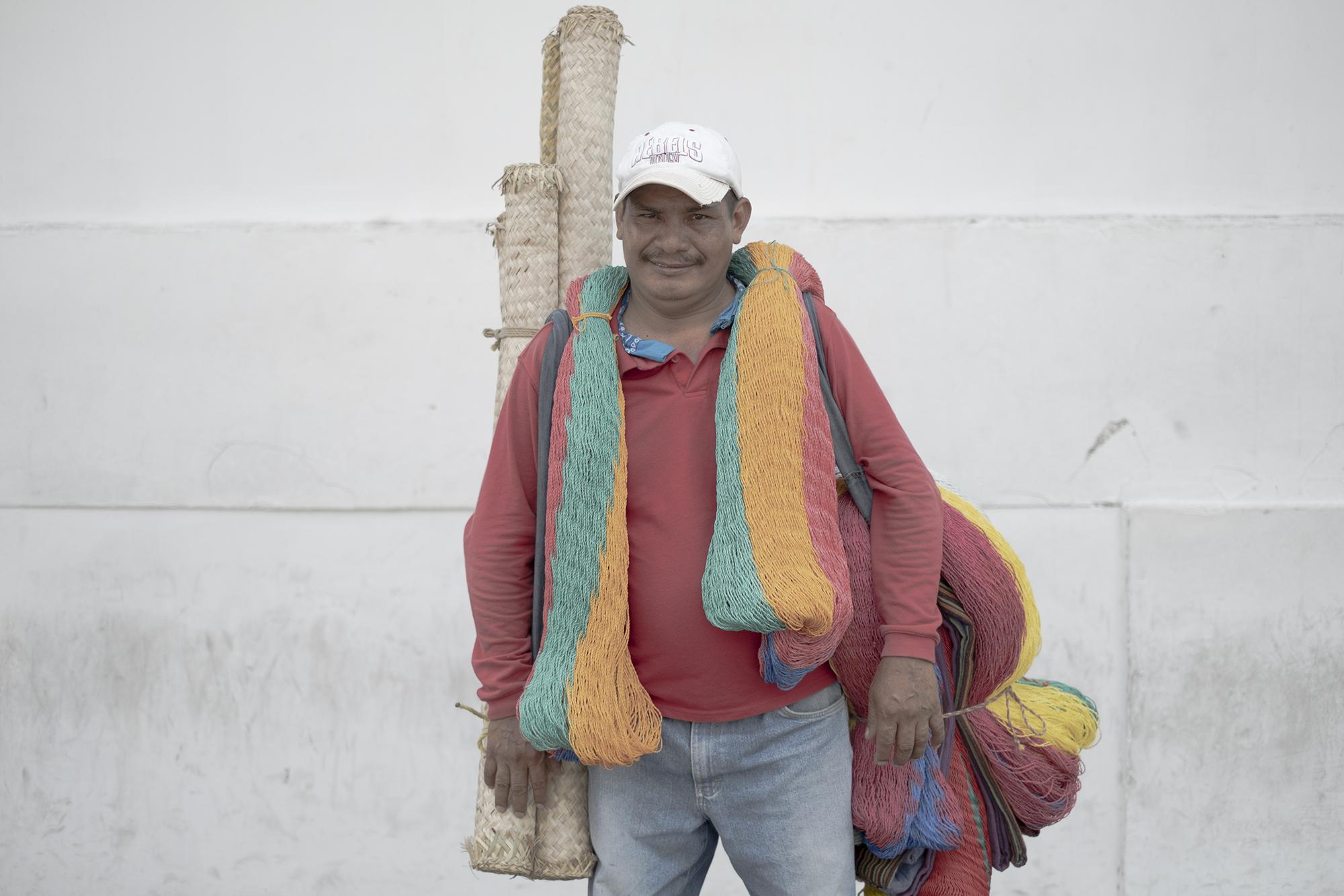 Eduardo Tunakalet, 50, travels between his home in Sensuntepeque and different neighborhoods of San Salvador selling hammocks and mats. His sales support his wife and two children. “Staying home leaves me and my family without sustenance. I’ll be careful, but I will always go out to sell,” he stated.